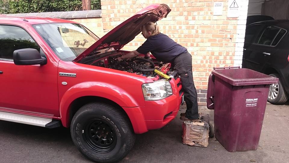 A van and a car parked together at the workshop